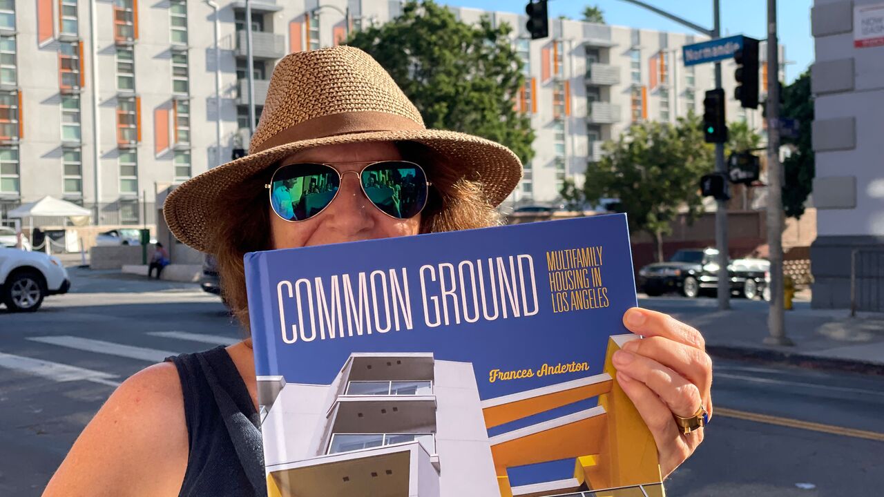 2025 Artist Fellowship grantee Frances Anderton holds a copy of the book Common Ground in front of her face